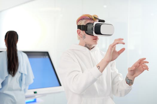 Young man engaged in a virtual reality experience indoors wearing white hoodie and VR goggles.