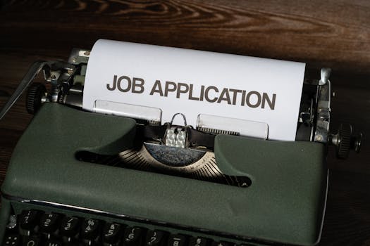 Close-up of a vintage typewriter with a job application paper inserted.